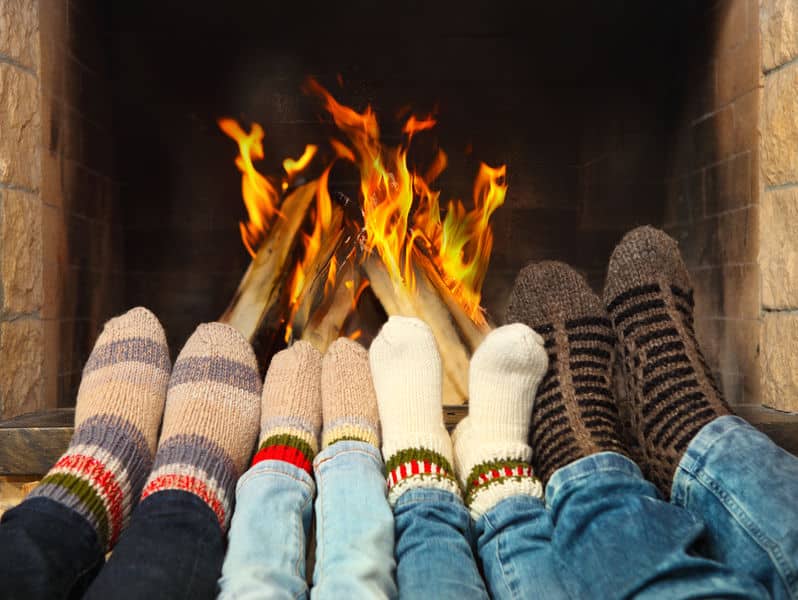 family warming feet in front of fireplace in salt lake city ut